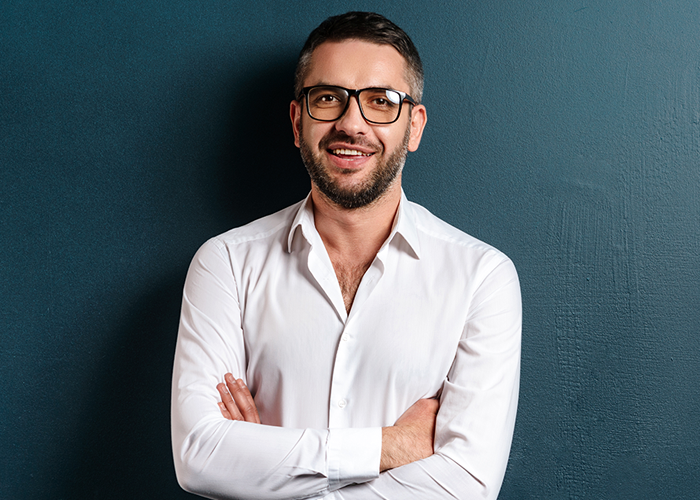 A man with glasses in white shirt