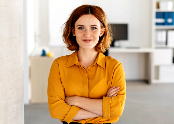 A woman with short hair in yellow shirt